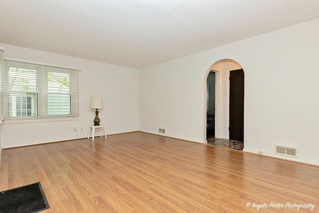 2618 Kashmiri Ave, Mchenry, IL 60050 - unfurnished room featuring arched walkways, light wood-type flooring, and baseboards