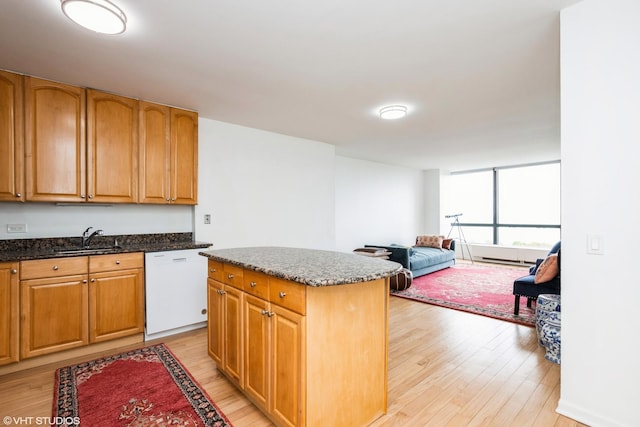 5415 N Sheridan Rd Unit 1504, Chicago, IL 60640 - kitchen featuring dishwasher, a sink, light wood-type flooring, and dark stone counters