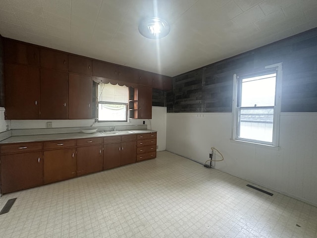 107 W S St, Morrison, IL 61270 - kitchen featuring a wainscoted wall, light floors, light countertops, and a sink