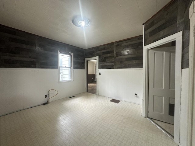 107 W S St, Morrison, IL 61270 - empty room with a wainscoted wall and wood walls