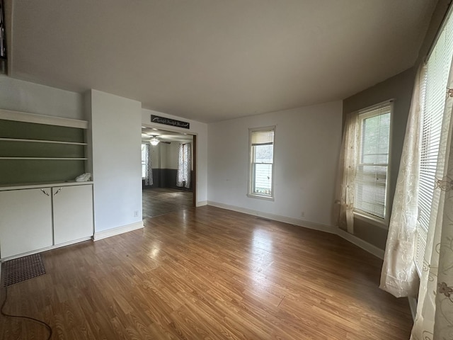 107 W S St, Morrison, IL 61270 - unfurnished living room featuring wood finished floors, baseboards, and ceiling fan