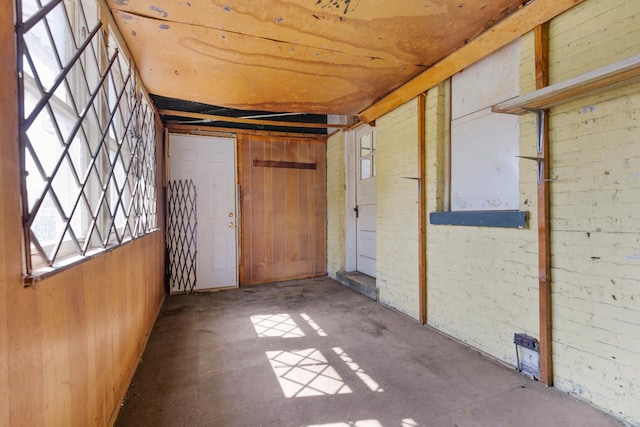 7703 S Loomis Blvd, Chicago, IL 60620 - unfurnished room with wooden walls and concrete floors