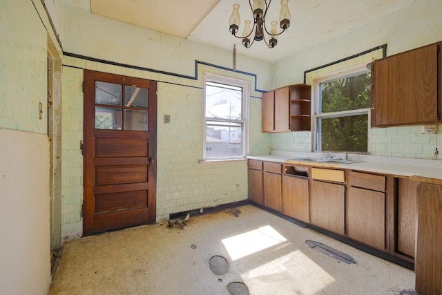 7703 S Loomis Blvd, Chicago, IL 60620 - kitchen with a chandelier, light countertops, open shelves, and brown cabinetry