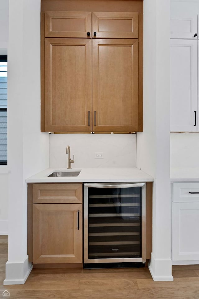 3905 N Drake Ave, Chicago, IL 60618 - indoor wet bar featuring wine cooler, light wood-style flooring, and baseboards