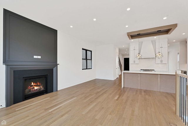 3905 N Drake Ave, Chicago, IL 60618 - unfurnished living room with light wood finished floors, a fireplace, and recessed lighting