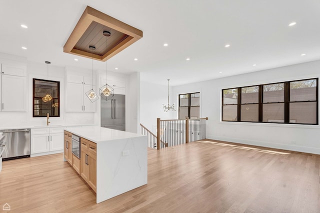 3905 N Drake Ave, Chicago, IL 60618 - kitchen with built in appliances, a sink, a chandelier, light wood-style flooring, and recessed lighting
