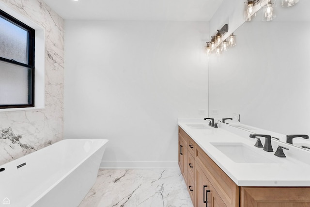 3905 N Drake Ave, Chicago, IL 60618 - full bathroom featuring double vanity, a freestanding bath, marble finish flooring, and baseboards