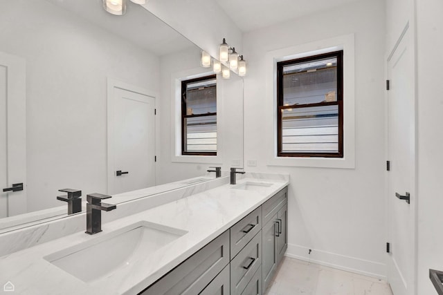 3905 N Drake Ave, Chicago, IL 60618 - full bathroom featuring baseboards, double vanity, and marble finish flooring