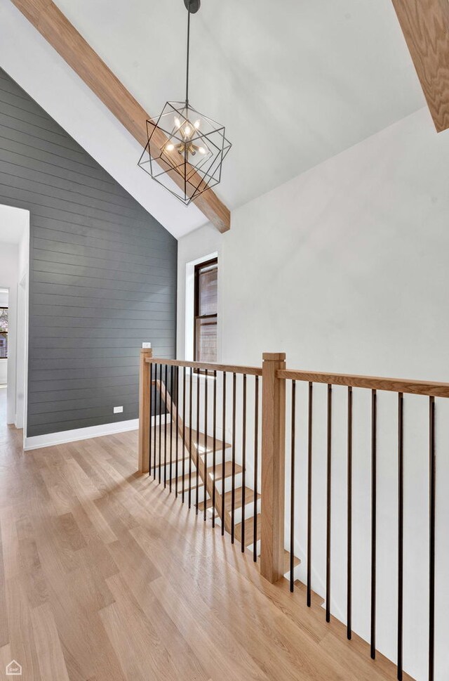 3905 N Drake Ave, Chicago, IL 60618 - stairway with wood finished floors, a chandelier, and baseboards