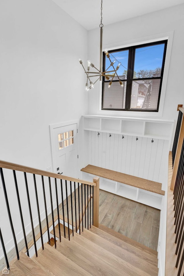3905 N Drake Ave, Chicago, IL 60618 - stairs with wood finished floors and a chandelier