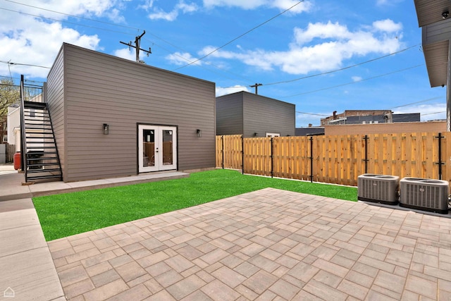 3905 N Drake Ave, Chicago, IL 60618 - view of patio / terrace with central AC, stairway, and french doors