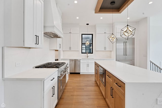 3905 N Drake Ave, Chicago, IL 60618 - kitchen featuring built in appliances, premium range hood, a sink, recessed lighting, and a kitchen island