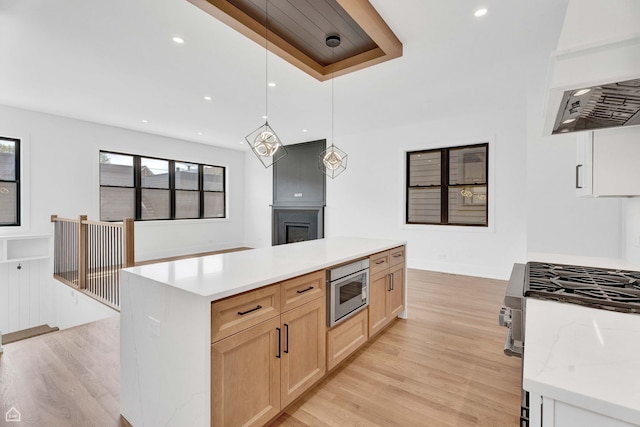 3905 N Drake Ave, Chicago, IL 60618 - kitchen with stainless steel appliances, light brown cabinets, custom range hood, light wood-style flooring, and recessed lighting