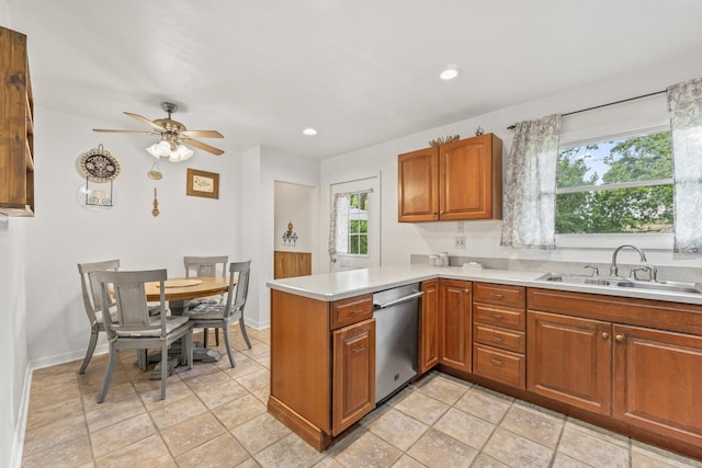 2N439 Bernice Ave, Glen Ellyn, IL 60137 - kitchen featuring stainless steel dishwasher, a sink, a peninsula, light countertops, and brown cabinetry