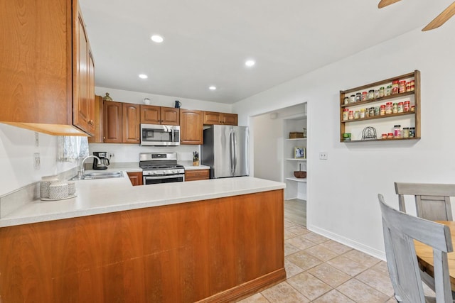 2N439 Bernice Ave, Glen Ellyn, IL 60137 - kitchen with stainless steel appliances, a sink, brown cabinetry, a peninsula, and light countertops