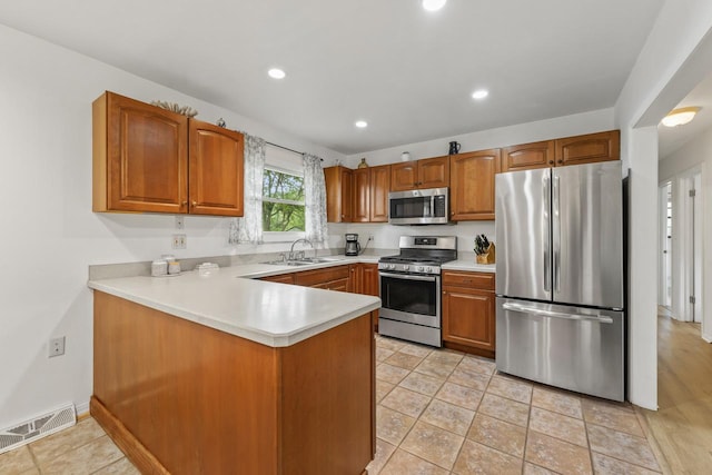 2N439 Bernice Ave, Glen Ellyn, IL 60137 - kitchen with appliances with stainless steel finishes, brown cabinets, light countertops, a peninsula, and recessed lighting