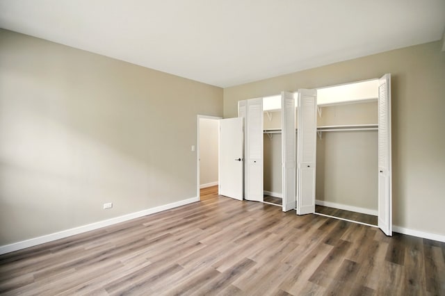 9009 Golf Rd Unit 1C, Des Plaines, IL 60016 - unfurnished bedroom featuring wood finished floors and baseboards