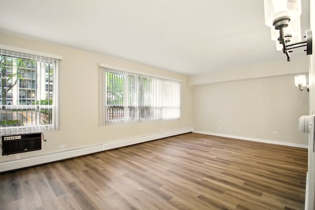 9009 Golf Rd Unit 1C, Des Plaines, IL 60016 - spare room featuring wood finished floors, baseboard heating, and baseboards