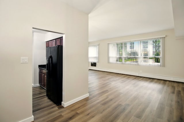9009 Golf Rd Unit 1C, Des Plaines, IL 60016 - unfurnished living room with healthy amount of natural light, dark wood-style floors, baseboards, and lofted ceiling