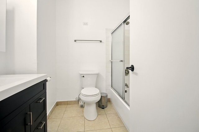 9009 Golf Rd Unit 1C, Des Plaines, IL 60016 - full bath with toilet, vanity, baseboards, tile patterned flooring, and shower / bath combination with glass door