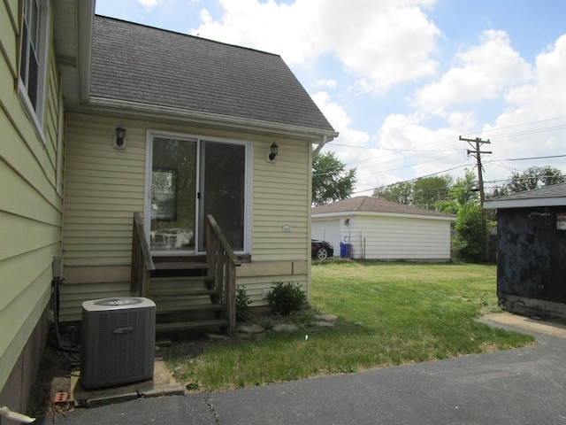 786 N Van Auken St, Elmhurst, IL 60126 - view of property exterior with central AC unit, a yard, roof with shingles, and entry steps
