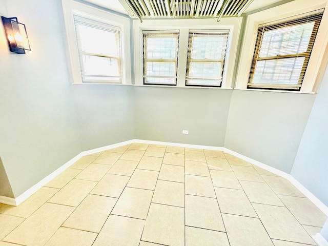 2300 W Granville Ave Unit G, Chicago, IL 60659 - empty room with healthy amount of natural light, light tile patterned flooring, and baseboards