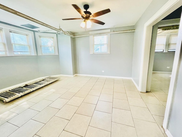2300 W Granville Ave Unit G, Chicago, IL 60659 - empty room featuring ceiling fan, light tile patterned flooring, and baseboards