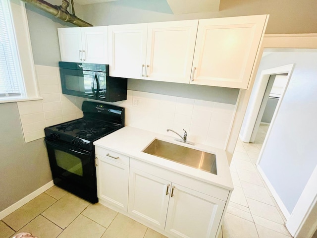 2300 W Granville Ave Unit G, Chicago, IL 60659 - kitchen featuring black appliances, a sink, light tile patterned floors, and tasteful backsplash