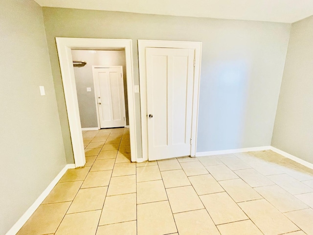2300 W Granville Ave Unit G, Chicago, IL 60659 - unfurnished bedroom featuring light tile patterned floors and baseboards