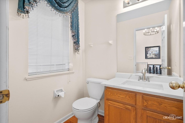 2539 Lexington Ln, Naperville, IL 60540 - bathroom with vanity, toilet, a chandelier, baseboards, and wood finished floors