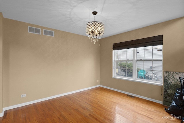 2539 Lexington Ln, Naperville, IL 60540 - unfurnished dining area featuring a chandelier, light wood finished floors, and baseboards