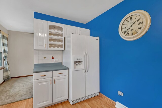 8 E Eureka St, Lemont, IL 60439 - kitchen featuring white refrigerator with ice dispenser, light wood-style flooring, white cabinets, and backsplash