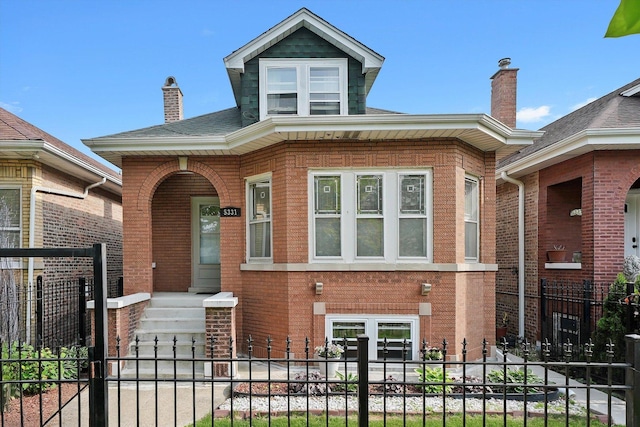 5331 W Schubert Ave, Chicago, IL 60639 - view of front of property with brick siding, a fenced front yard, a chimney, and a gate