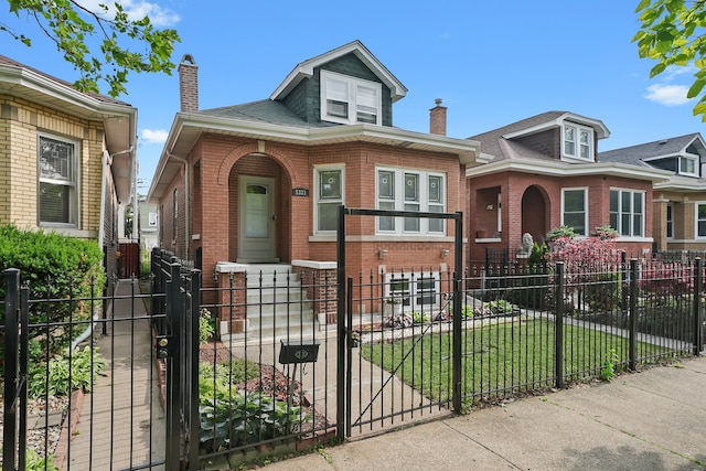 5331 W Schubert Ave, Chicago, IL 60639 - view of front facade featuring brick siding, a chimney, a fenced front yard, and a gate