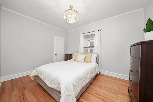5331 W Schubert Ave, Chicago, IL 60639 - bedroom with light wood-type flooring, ornamental molding, and a chandelier