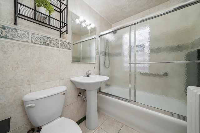 5331 W Schubert Ave, Chicago, IL 60639 - bathroom with radiator, combined bath / shower with glass door, tile patterned floors, and tile walls