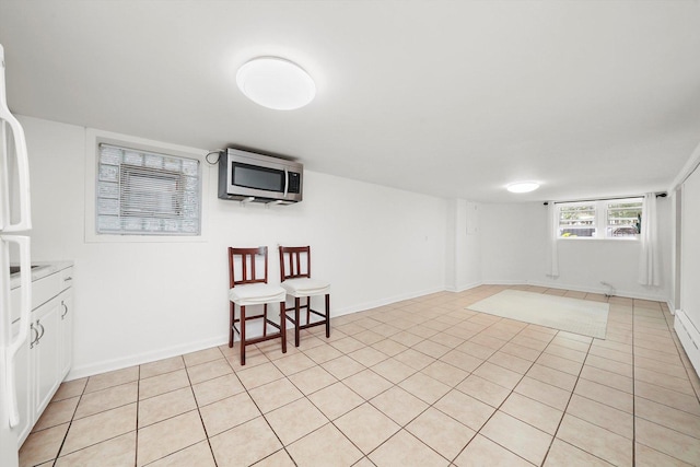 5331 W Schubert Ave, Chicago, IL 60639 - basement with light tile patterned floors and baseboards