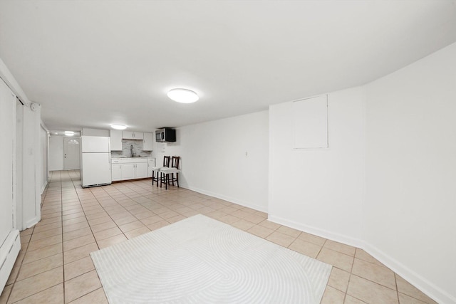 5331 W Schubert Ave, Chicago, IL 60639 - interior space with freestanding refrigerator, light tile patterned flooring, and baseboard heating