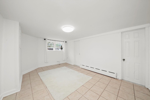 5331 W Schubert Ave, Chicago, IL 60639 - empty room with a baseboard heating unit and light tile patterned floors