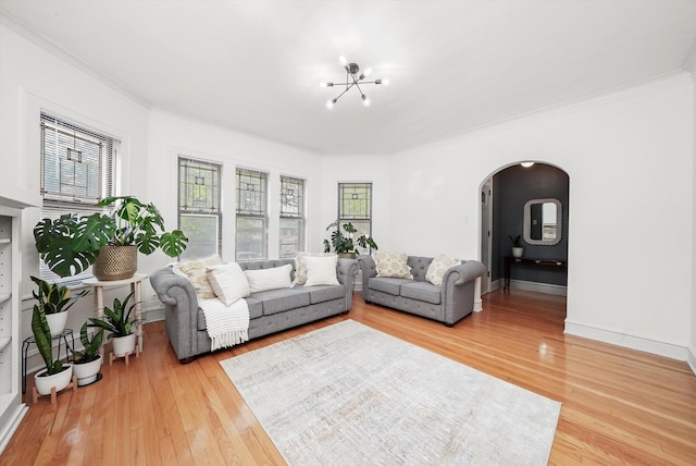 5331 W Schubert Ave, Chicago, IL 60639 - living room featuring arched walkways, light wood finished floors, crown molding, and a chandelier