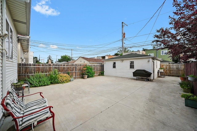 5331 W Schubert Ave, Chicago, IL 60639 - fenced backyard with a patio, grilling area, and an outbuilding