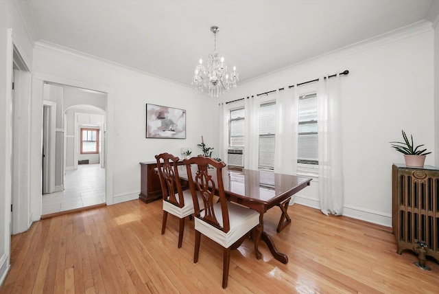 5331 W Schubert Ave, Chicago, IL 60639 - dining area with radiator, arched walkways, light wood-style floors, a chandelier, and crown molding