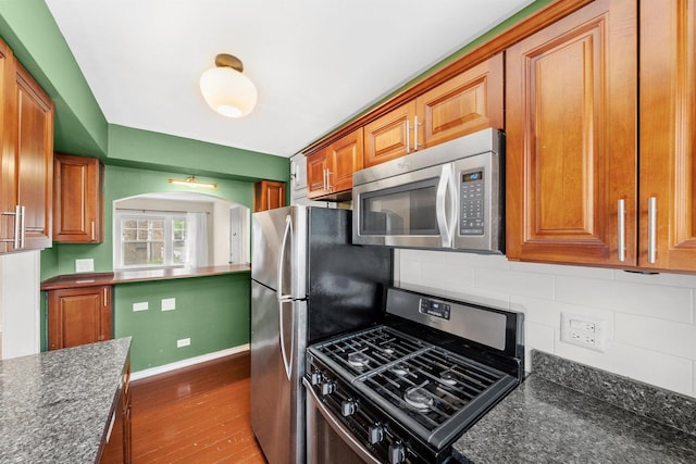213 N Marion St Unit 1C, Oak Park, IL 60302 - kitchen featuring appliances with stainless steel finishes, backsplash, brown cabinets, and dark wood finished floors