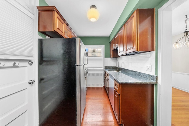 213 N Marion St Unit 1C, Oak Park, IL 60302 - kitchen featuring appliances with stainless steel finishes, light wood finished floors, dark stone countertops, decorative backsplash, and a sink
