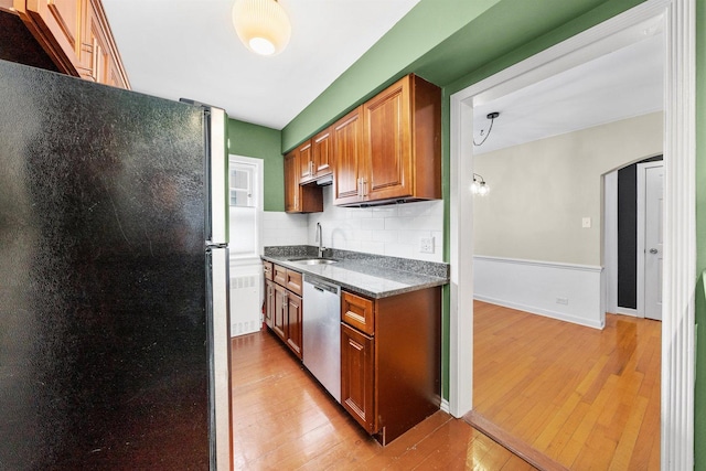 213 N Marion St Unit 1C, Oak Park, IL 60302 - kitchen with stainless steel appliances, a sink, light wood-style flooring, tasteful backsplash, and brown cabinetry