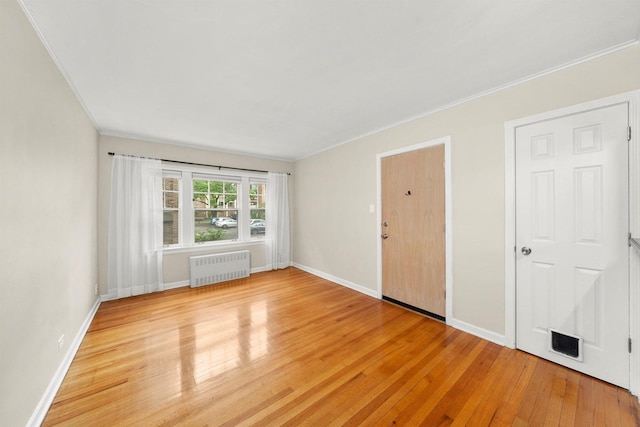 213 N Marion St Unit 1C, Oak Park, IL 60302 - empty room with radiator, ornamental molding, light wood-style floors, and baseboards