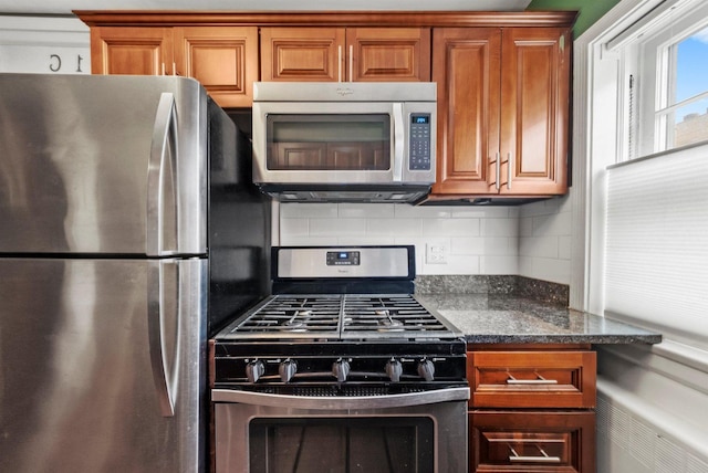 213 N Marion St Unit 1C, Oak Park, IL 60302 - kitchen with stainless steel appliances, brown cabinets, backsplash, and dark stone countertops