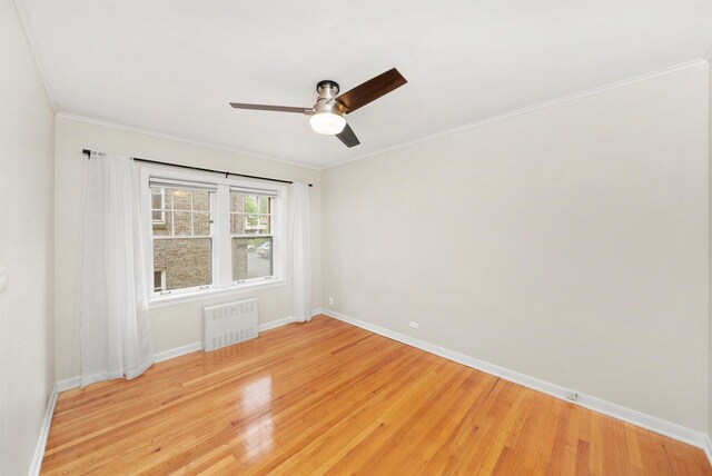 213 N Marion St Unit 1C, Oak Park, IL 60302 - empty room with radiator heating unit, baseboards, light wood finished floors, a ceiling fan, and ornamental molding