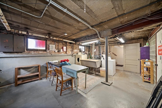 213 N Marion St Unit 1C, Oak Park, IL 60302 - below grade area with washing machine and dryer, healthy amount of natural light, electric panel, and a sink
