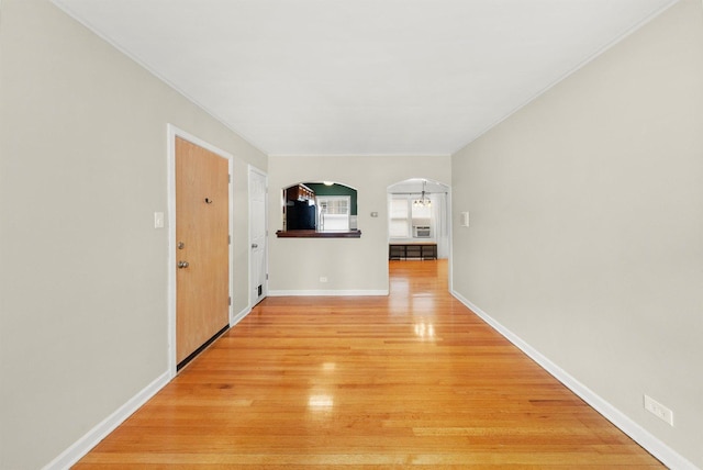 213 N Marion St Unit 1C, Oak Park, IL 60302 - hall with arched walkways, light wood-style floors, ornamental molding, and baseboards